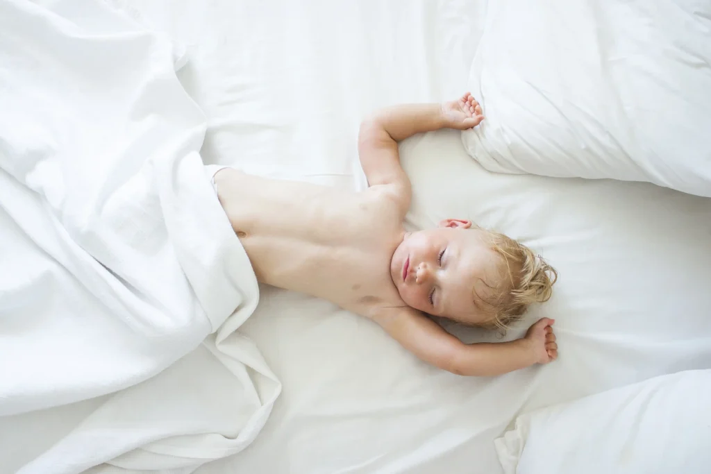 baby-sleeps-bed-with-white-sheets-concept-good-sound-baby-sleep-flat-lay-top-view-copy-space