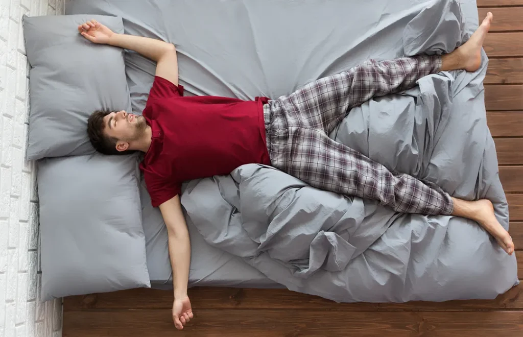 handsome-peaceful-man-sleeping-bed-home-top-view